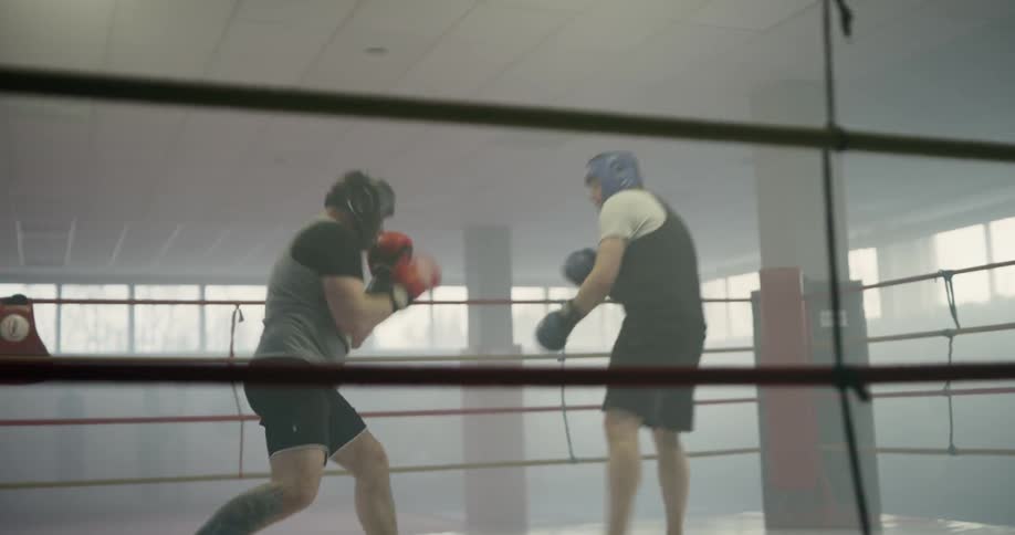 Two men in a boxing ring sparring