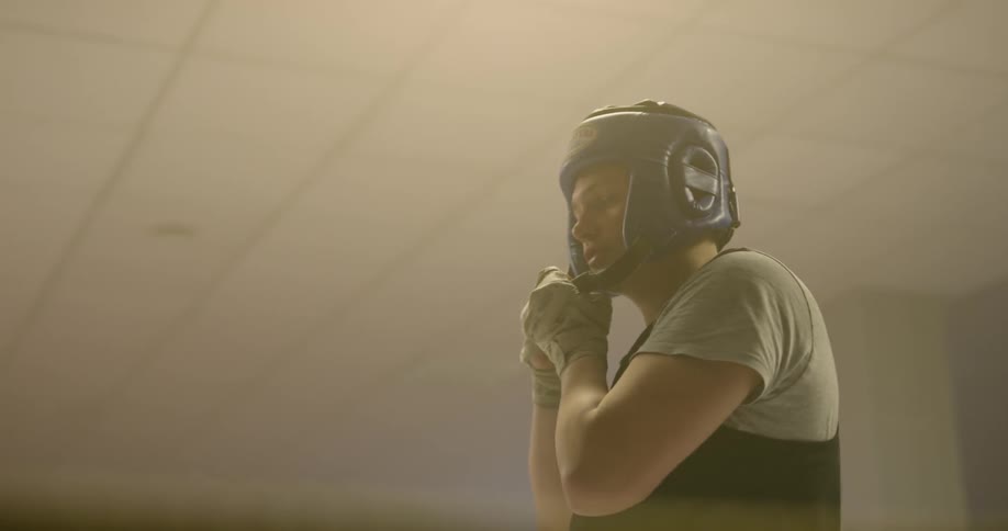 A boxer puts on a protective helmet before a fight