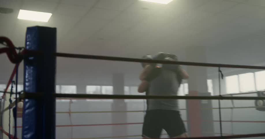 Two men box in a boxing ring