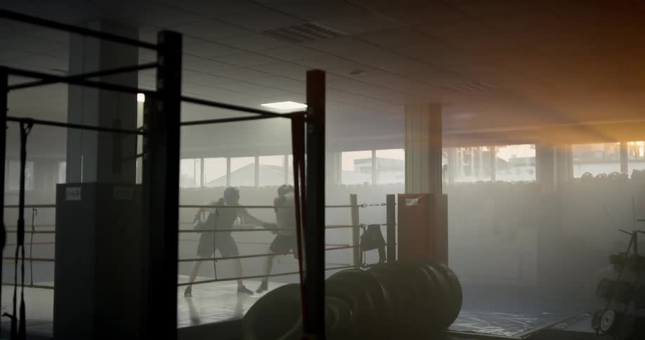 Two men box in a boxing ring