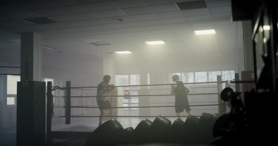 Two men throw punches in a boxing ring