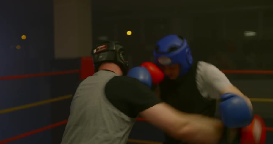 Two men are boxing in a ring together