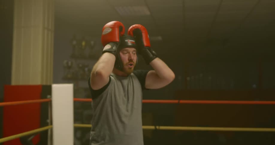 Two men box in a boxing ring