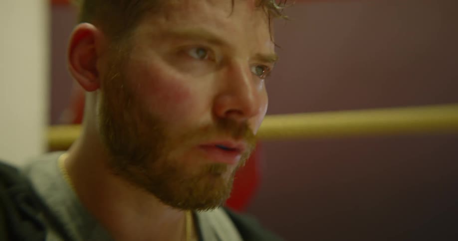 A man stares blankly ahead