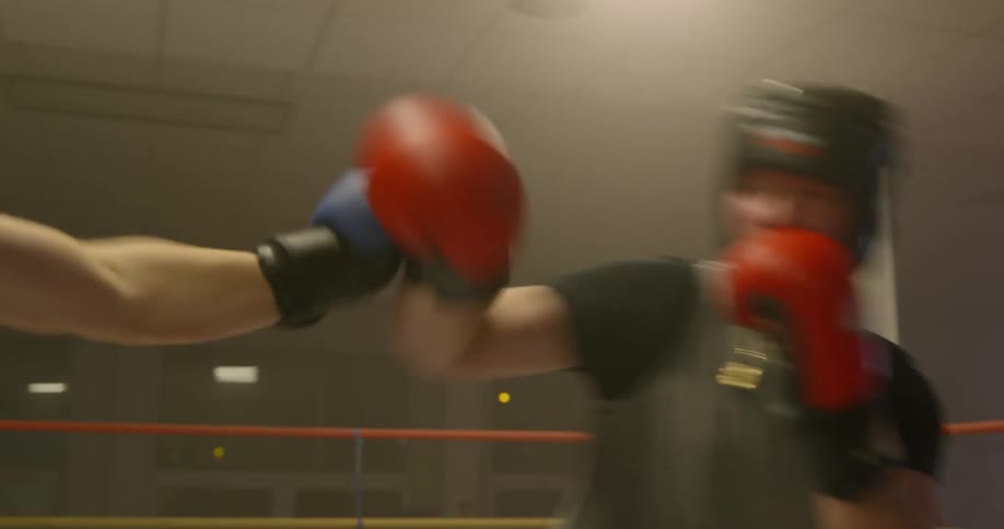 Two men box in a boxing ring