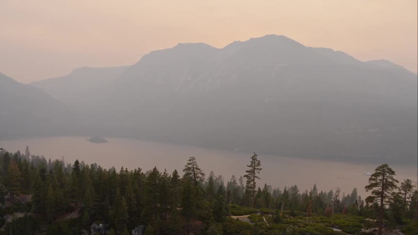 Aerial view of a lake with hills behind it