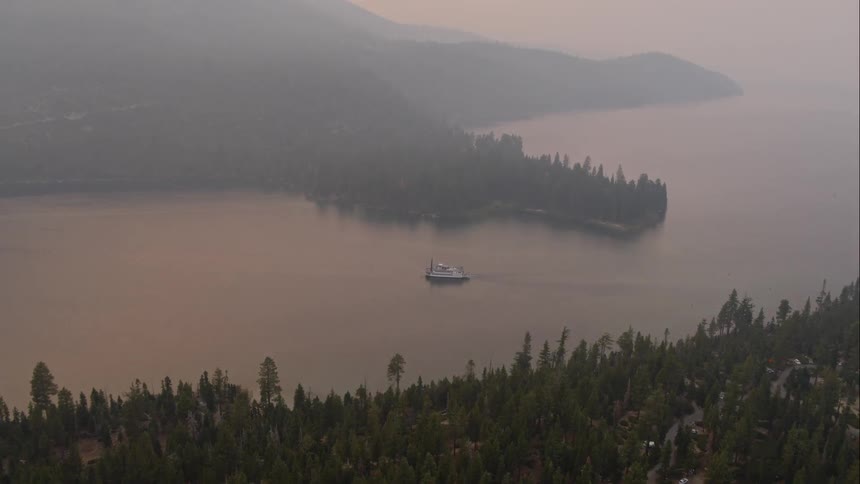 Fog sets over a coastal neighborhood and lake