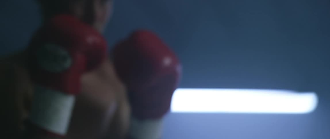 A boxer jumps and spars
