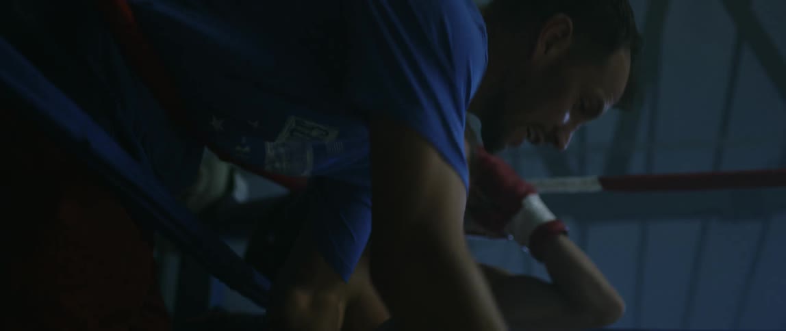 Boxer sitting in the corner of ring