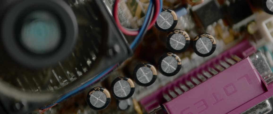 A fan turns then stops above electrical circuitry