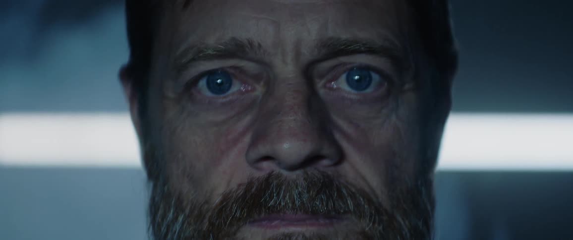 A man lifts up his head and opens his eyes