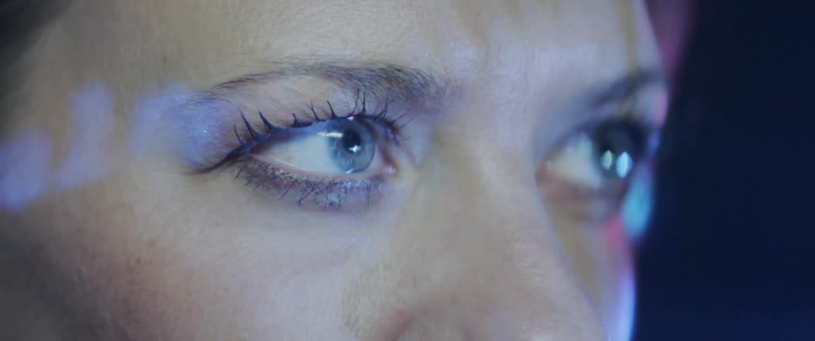 A woman is looking at a flashing image