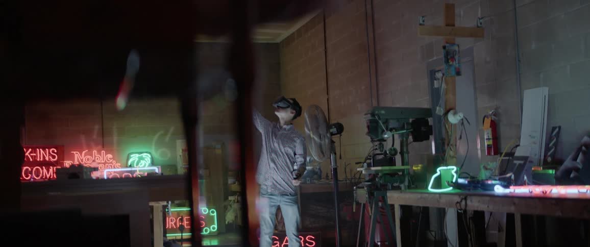 A man uses vr glasses inside of a garage