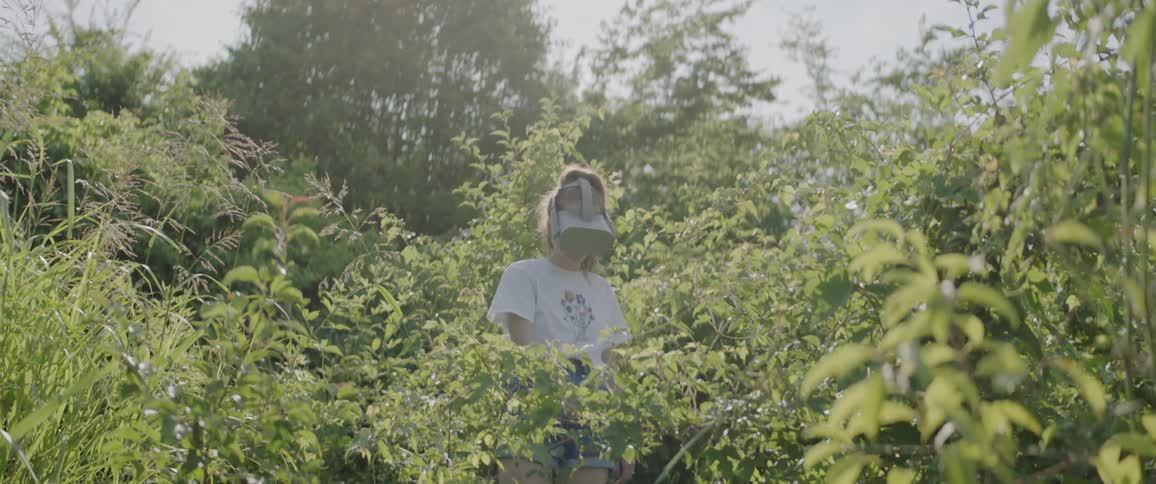 A young woman uses a virtual reality headset outdoors