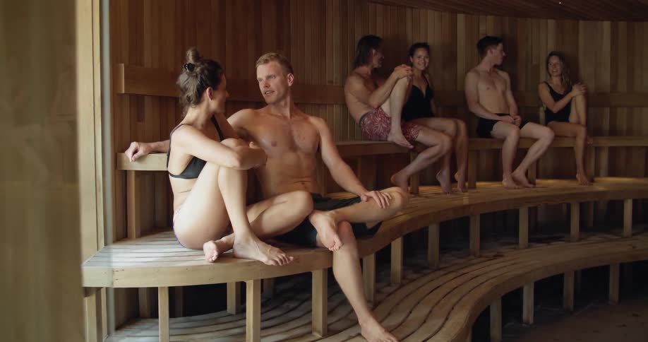Many people sit in a sauna