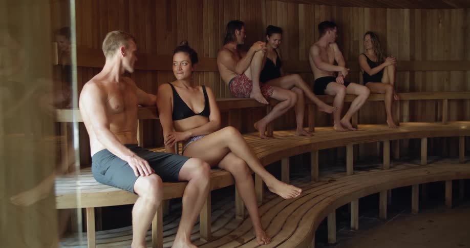 Couples sit in a sauna and talk