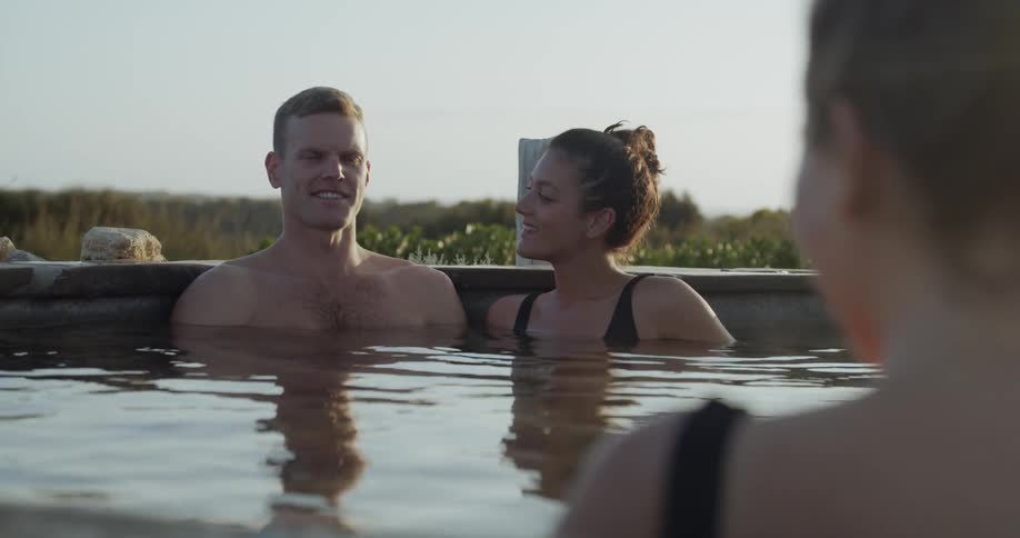 People relaxing in a hot tub outdoors at a resort
