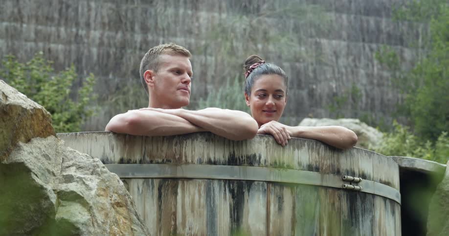 A man and woman bath in the pool together