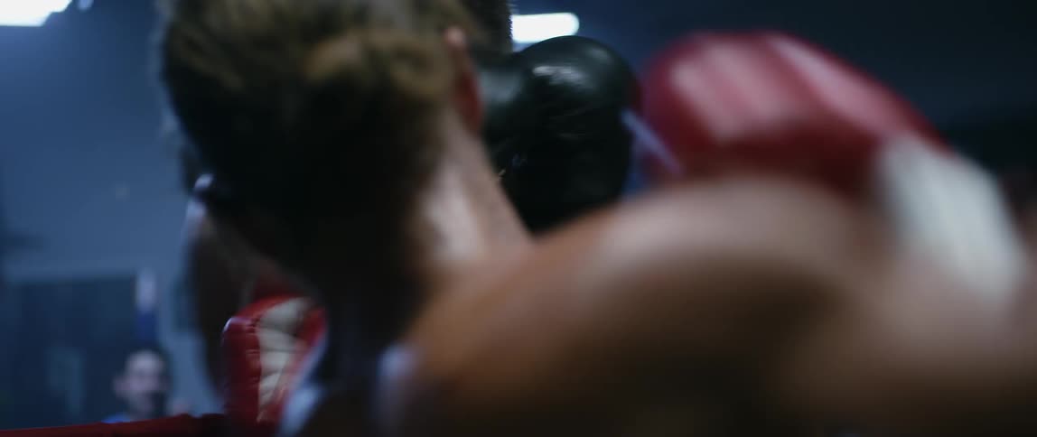 Two boxers are fighting in a ring