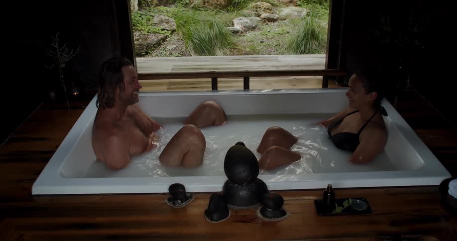 A couple take a bath together in the jacuzzi