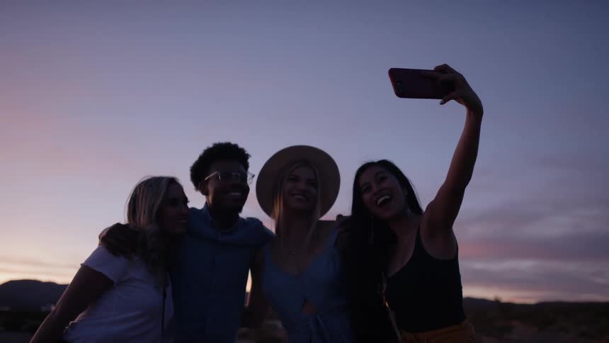 Friends take a selfie in the dark