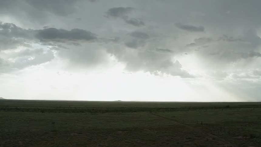 Storm clouds gather over a plain
