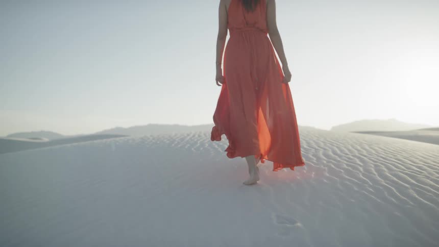 A woman is hiking in the desert