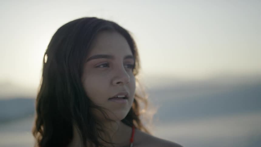 Woman looks around white desert dunes