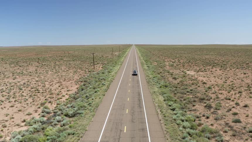 Car driving down a empty freeway