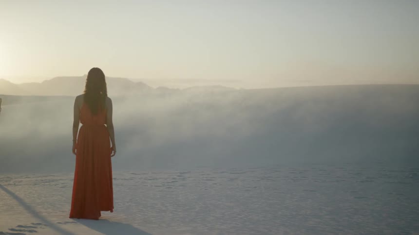A woman walking in a desert