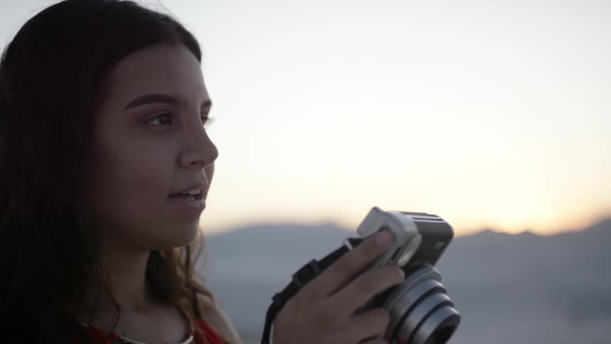 Woman reviews photos before scanning horizon