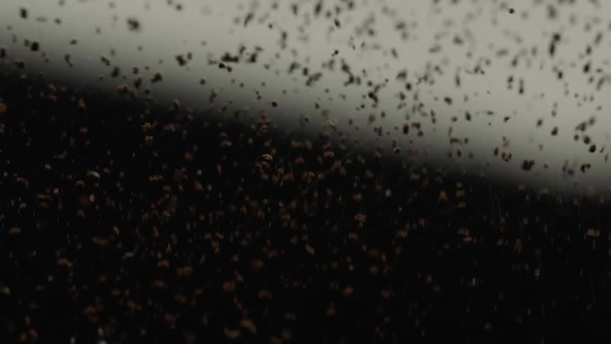 A brown material shaking on a machine