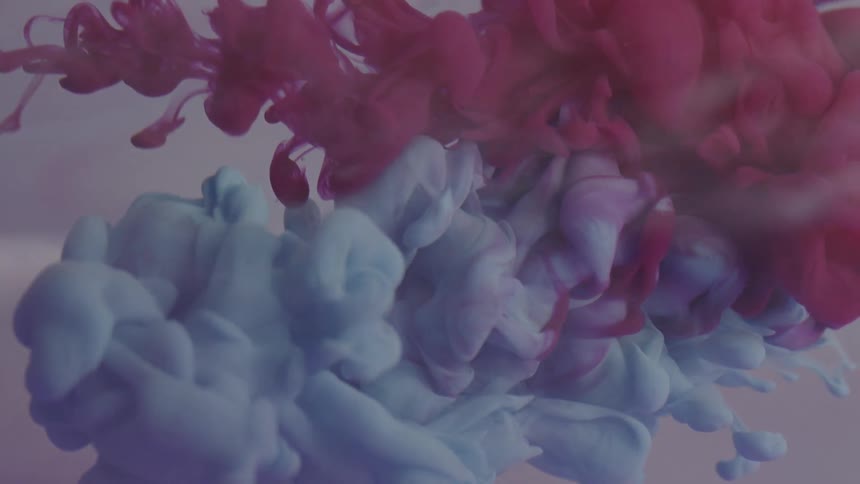 Two huge plumes of colored smoke or fluid mix together