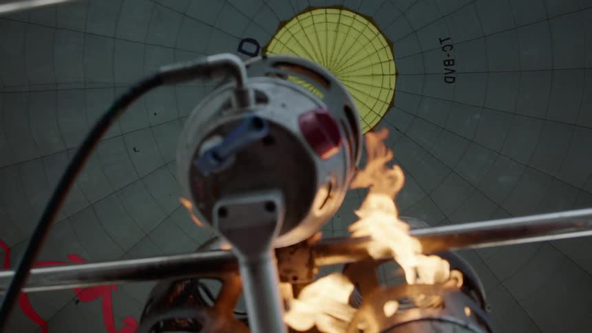 Flames shooting up to a yellow spot above from a futuristic machine