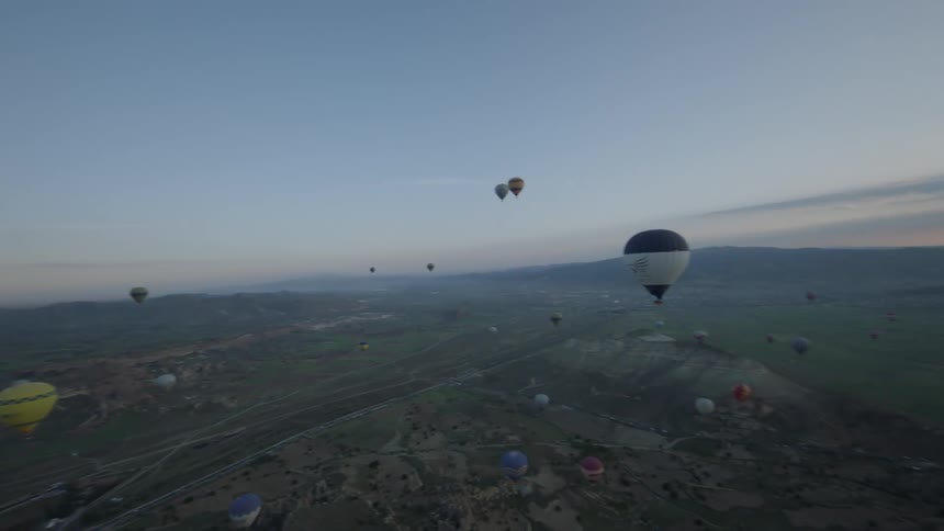 Hot air balloons flying above the countryside