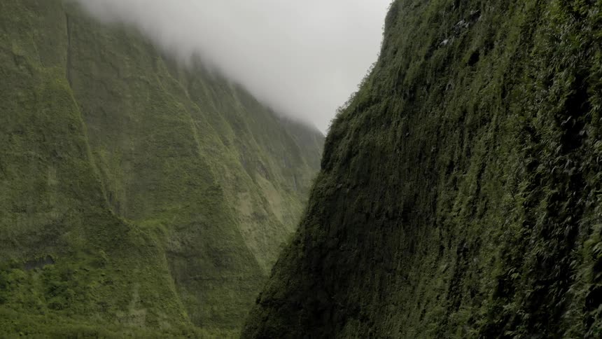 Moss covers sharp contours on the sides of mountains