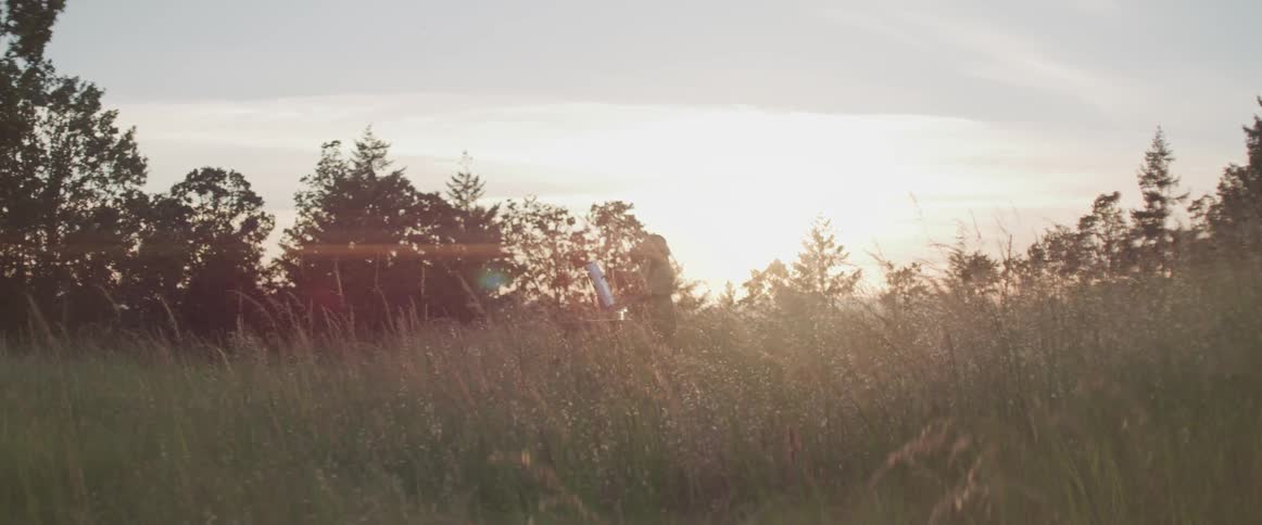 Person in the distance painting in the middle of a field in nature