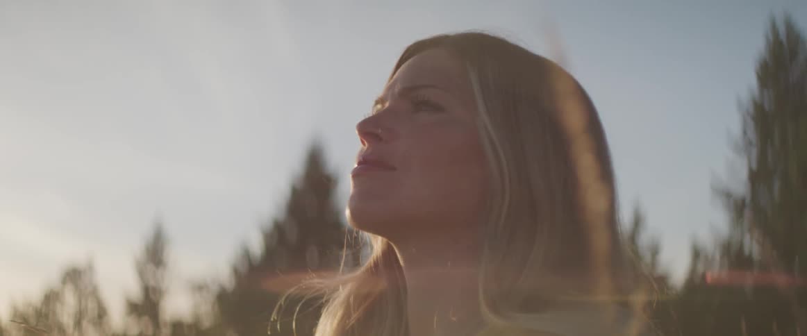 The woman stares into the sky