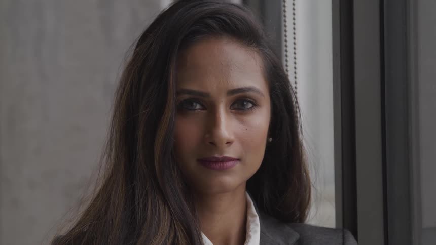 A woman looking into the camera confidently