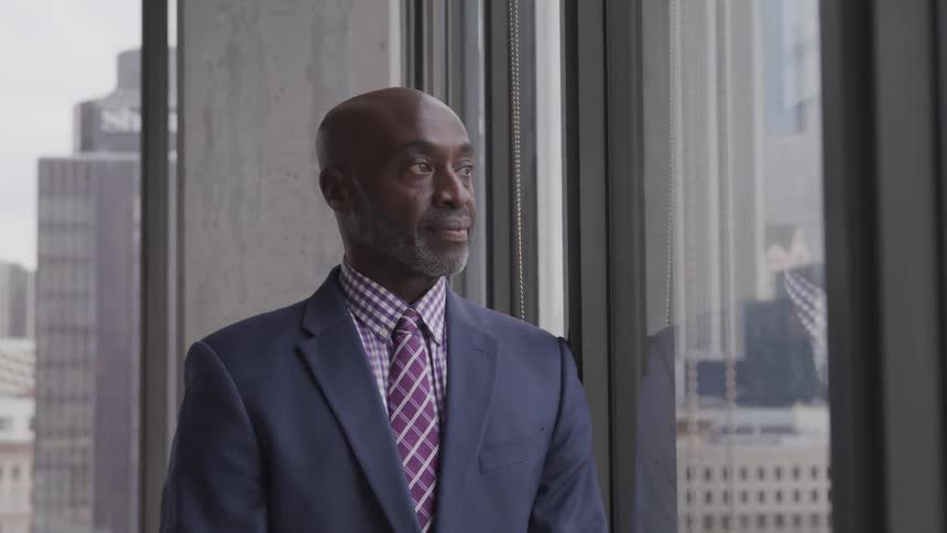 A black man staring at the window