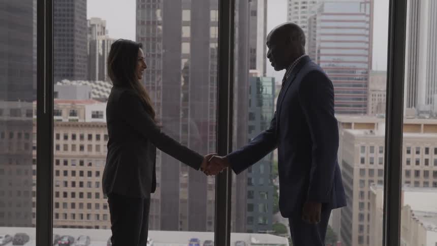 Two people shake hands