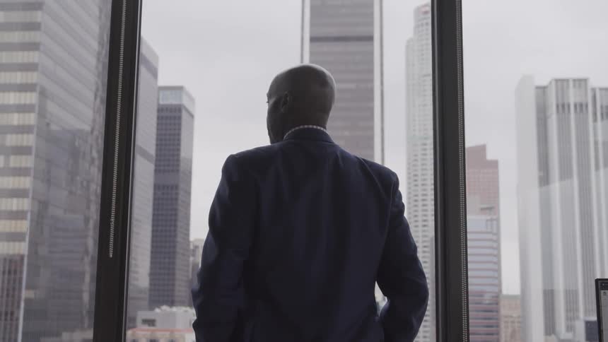 A man is looking out a window