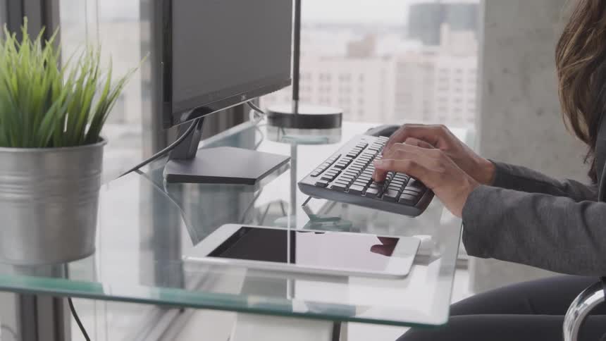 A woman types on the computer