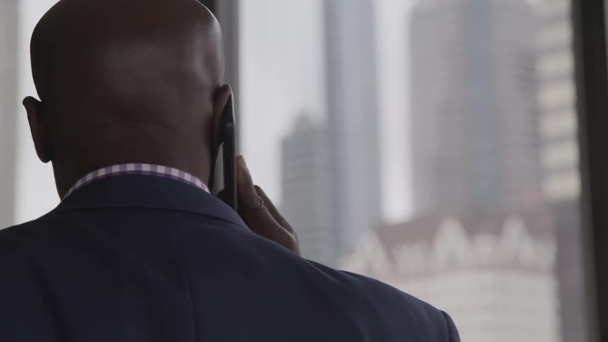 A black man talks on the phone