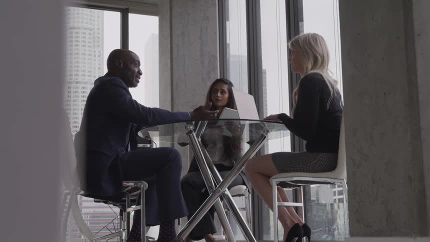 Three people have a meeting in the office