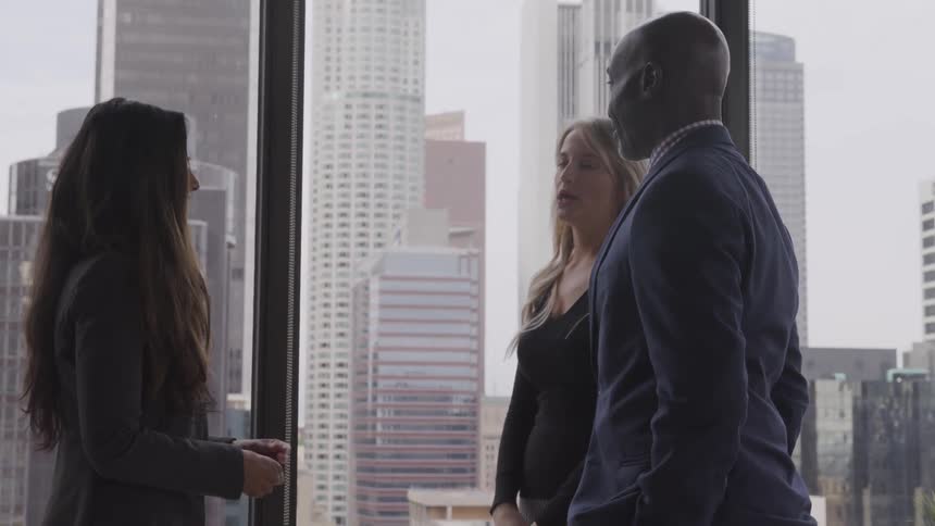 A group of people discussing in the office