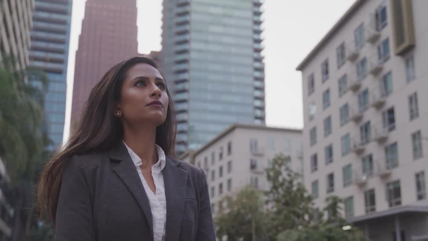 A woman with suit stand in the city