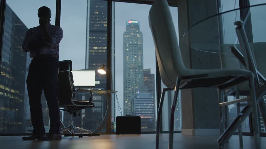 A man thinking in the office room at dawn