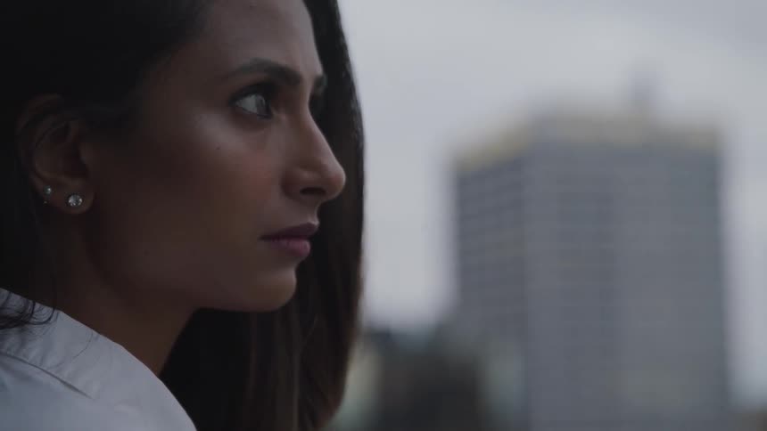 A woman standing outdoors in a city