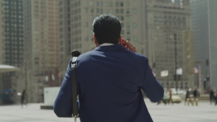 A man with suit are talking on the phone